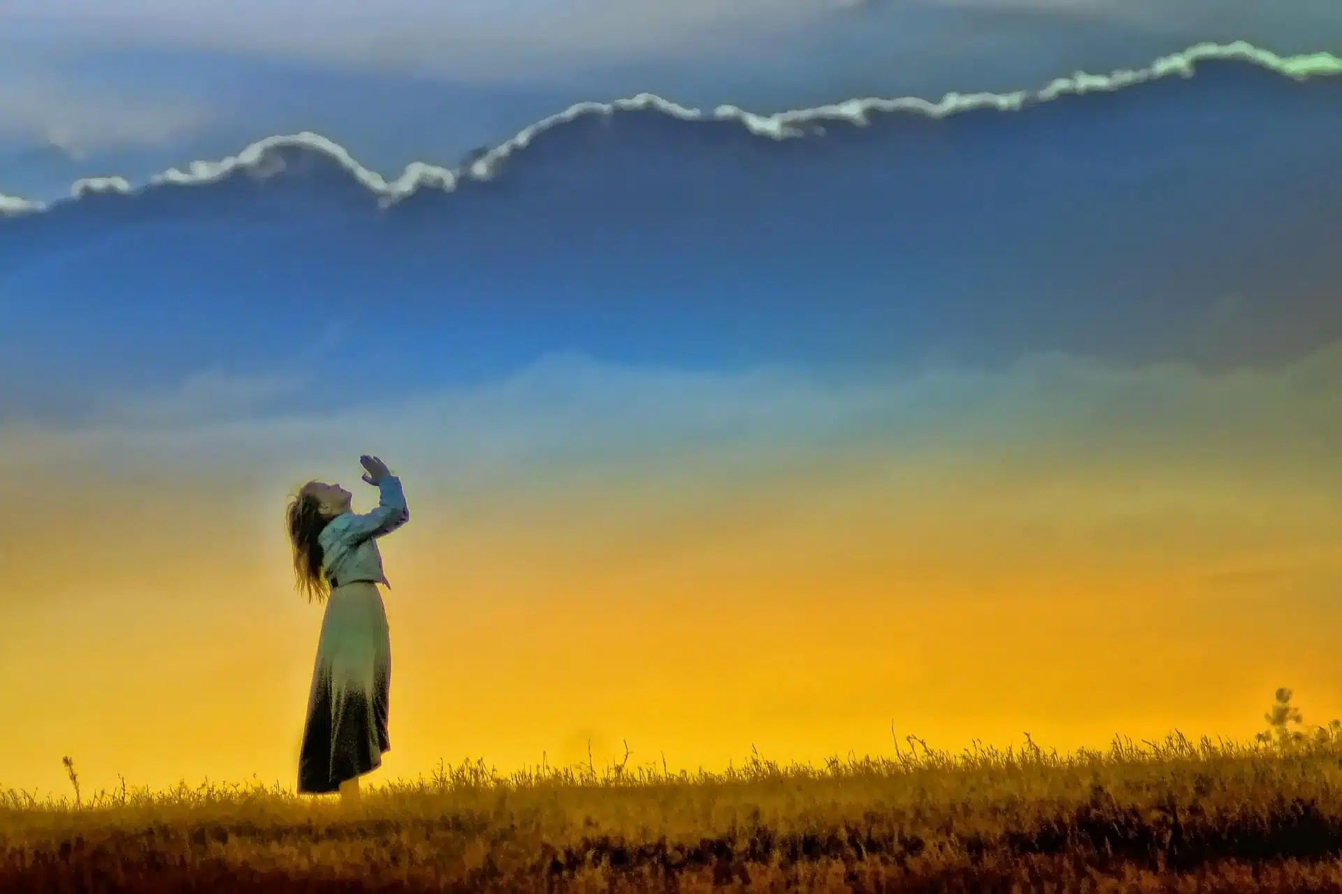 woman praying at sunrise