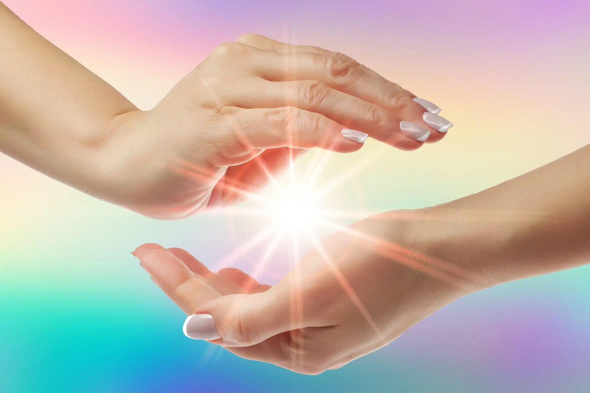 Women healing hands with bright sunburst on rainbow background